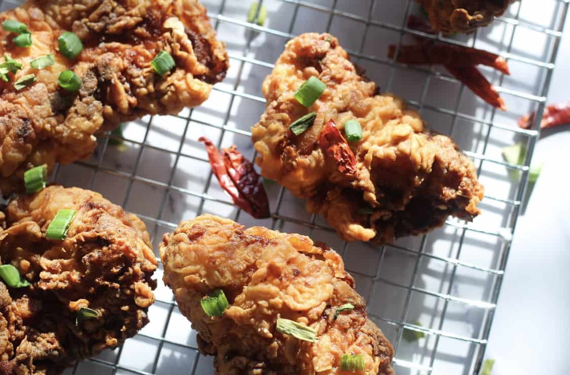 fried chicken cooling on a cooling rack