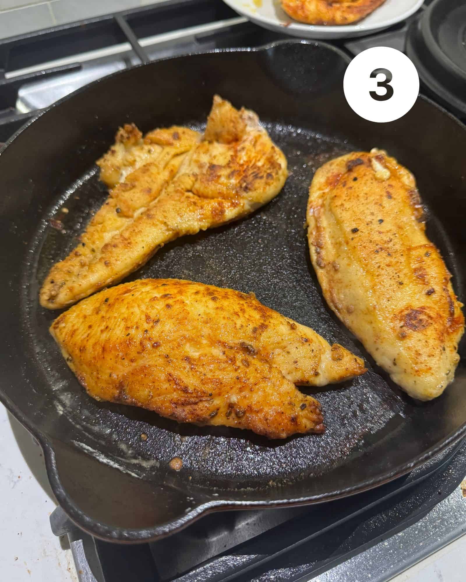 sauteed chicken in a cast iron skillet.