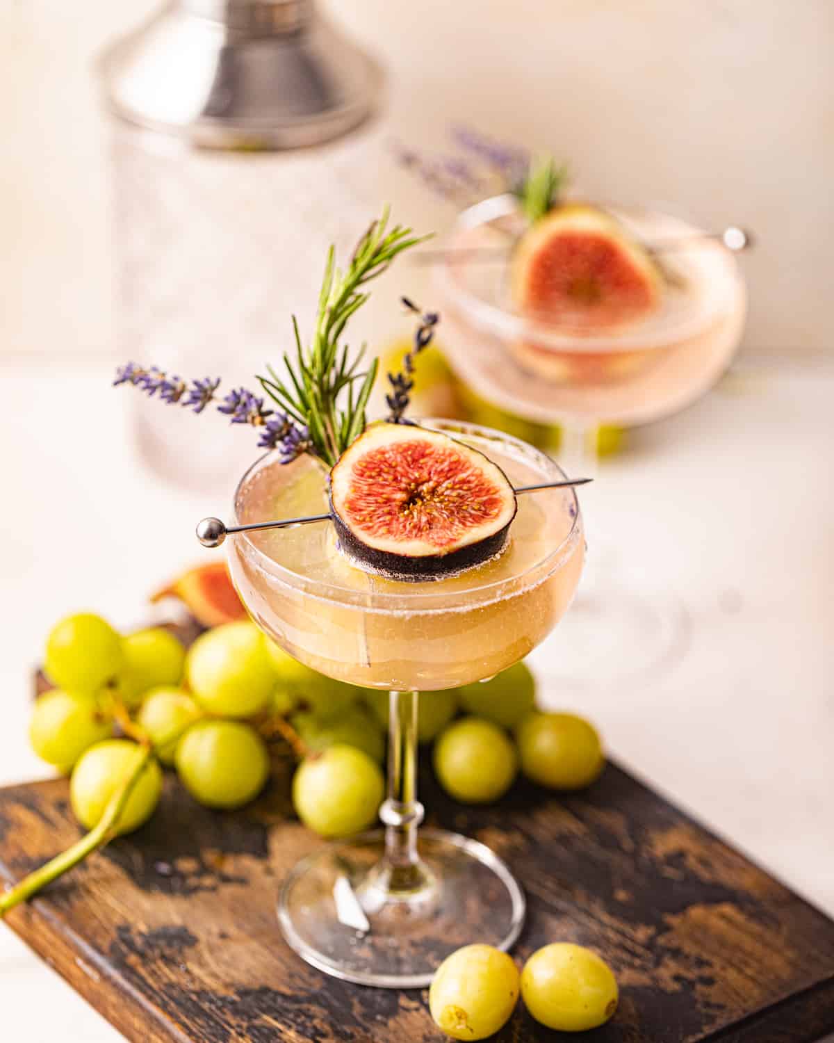 two cocktails on a serving board.