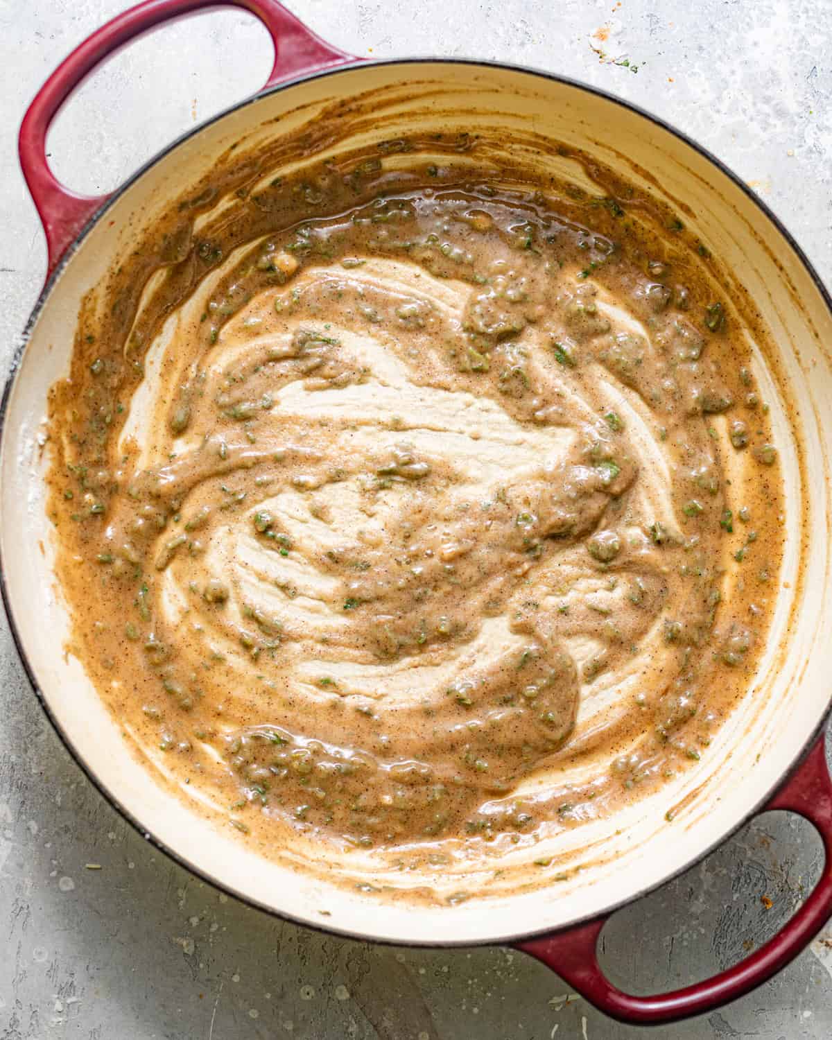roux for the pumpkin bechamel sauce whisked together in a pan. 