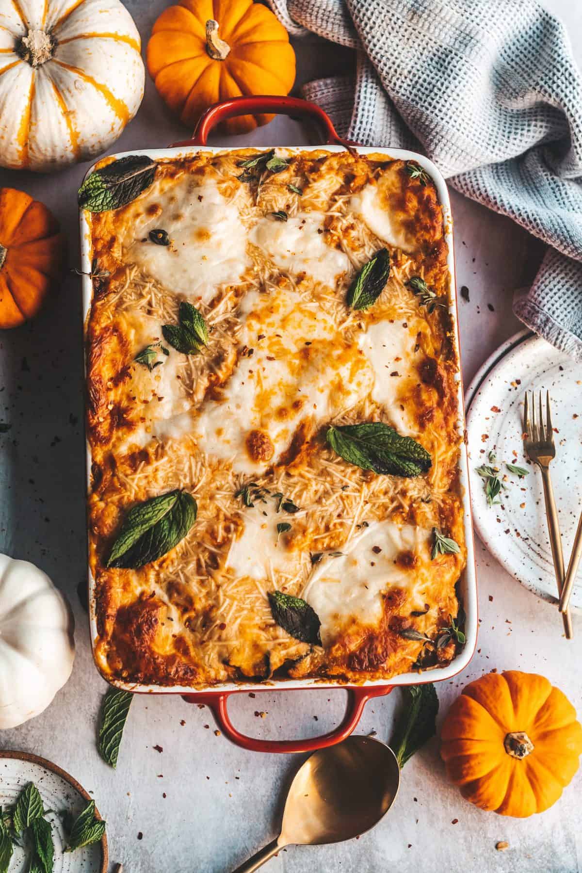 lasagna with pumpkins and plates