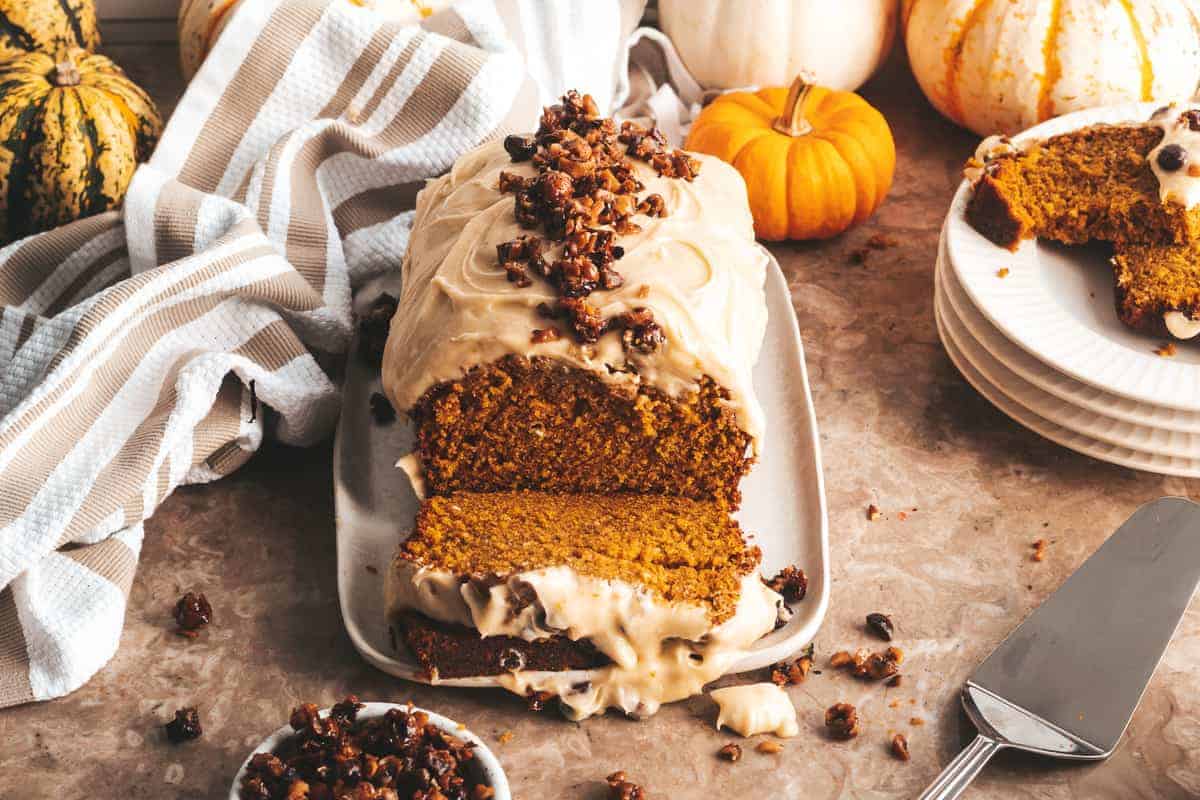 pumpkin bread sliced with pumpkin in the background