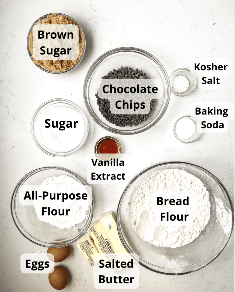 ingredients to make chocolate chip cookies - bread flour, flour, butter, brown sugar, sugar, chocolate chips, vanilla extract, eggs, baking soda, and kosher salt.