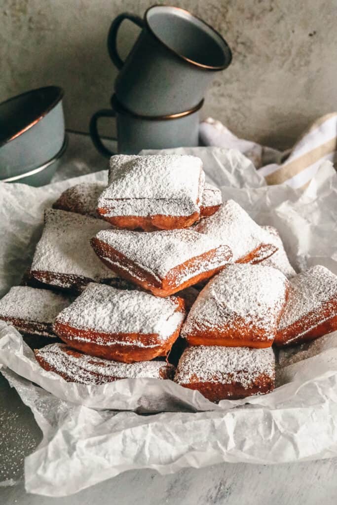 new orleans style beignets with powdered sugar in a basket