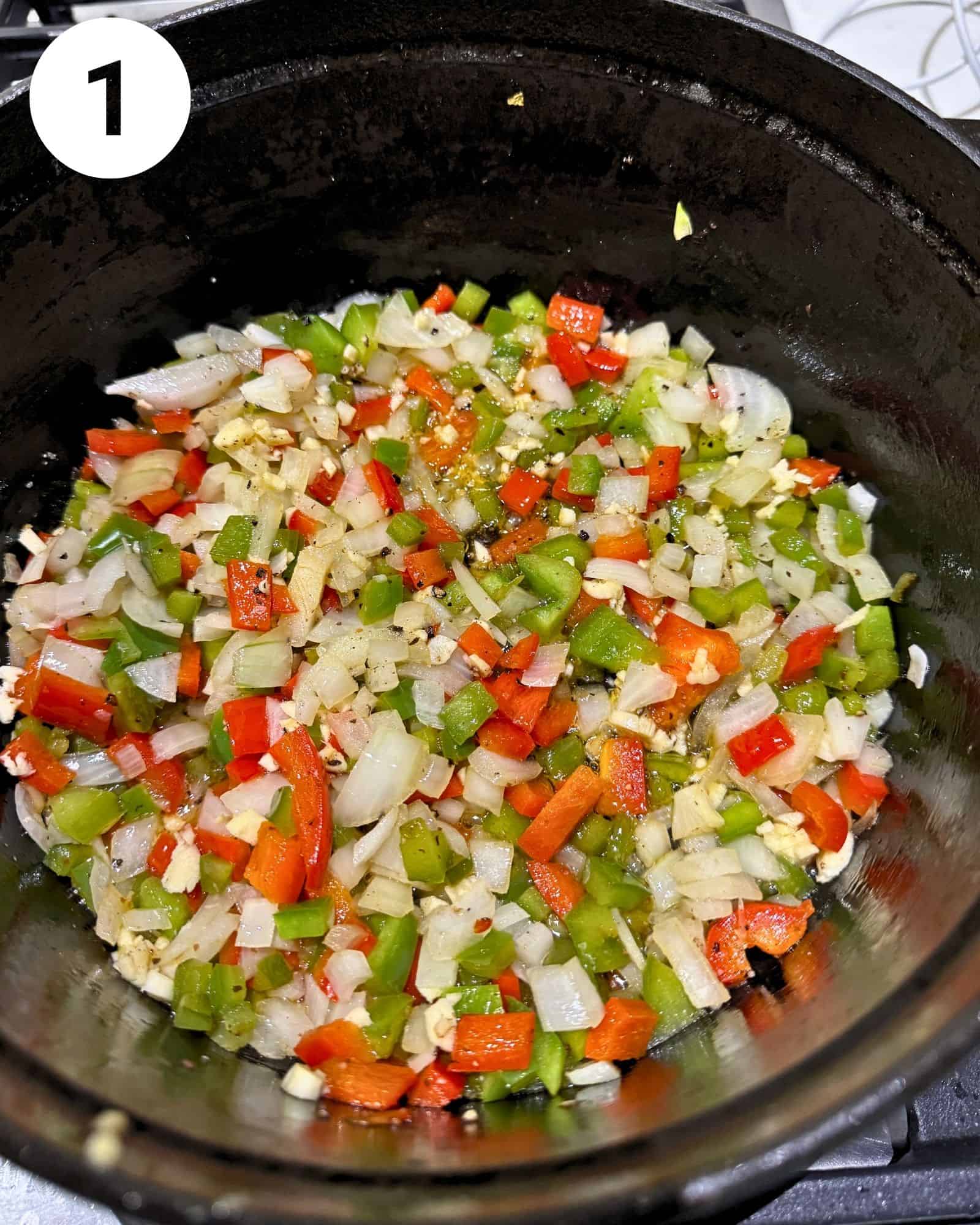 diced bell peppers, onions, garlic, and seasonings in a dutch oven.