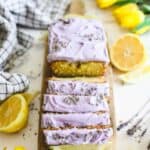 Lemon Olive Oil Loaf on a serving board with lavender and tulips topped with lavender mascarpone