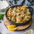 Pesto Shrimp Pasta with Sun-Dried Tomatoes in a skillet with parsley