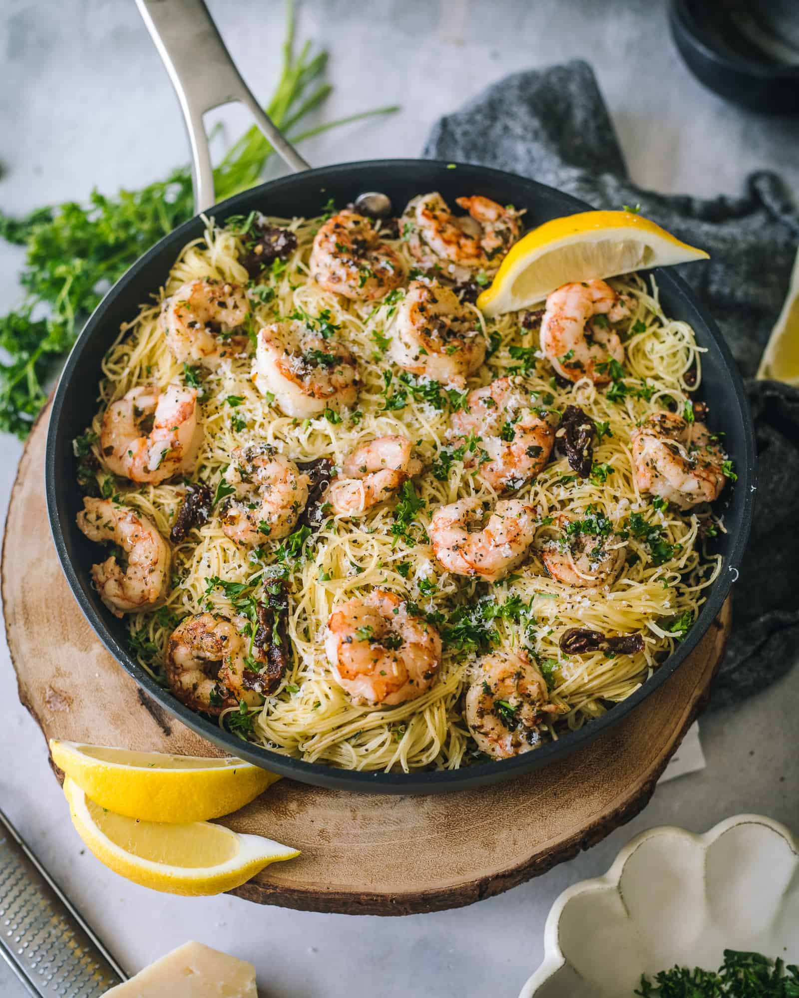 Pesto Shrimp Pasta with Sun-Dried Tomatoes in a skillet with parsley