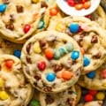 chewy chocolate chip cookies with m&ms on a silver serving tray with m&m candies.