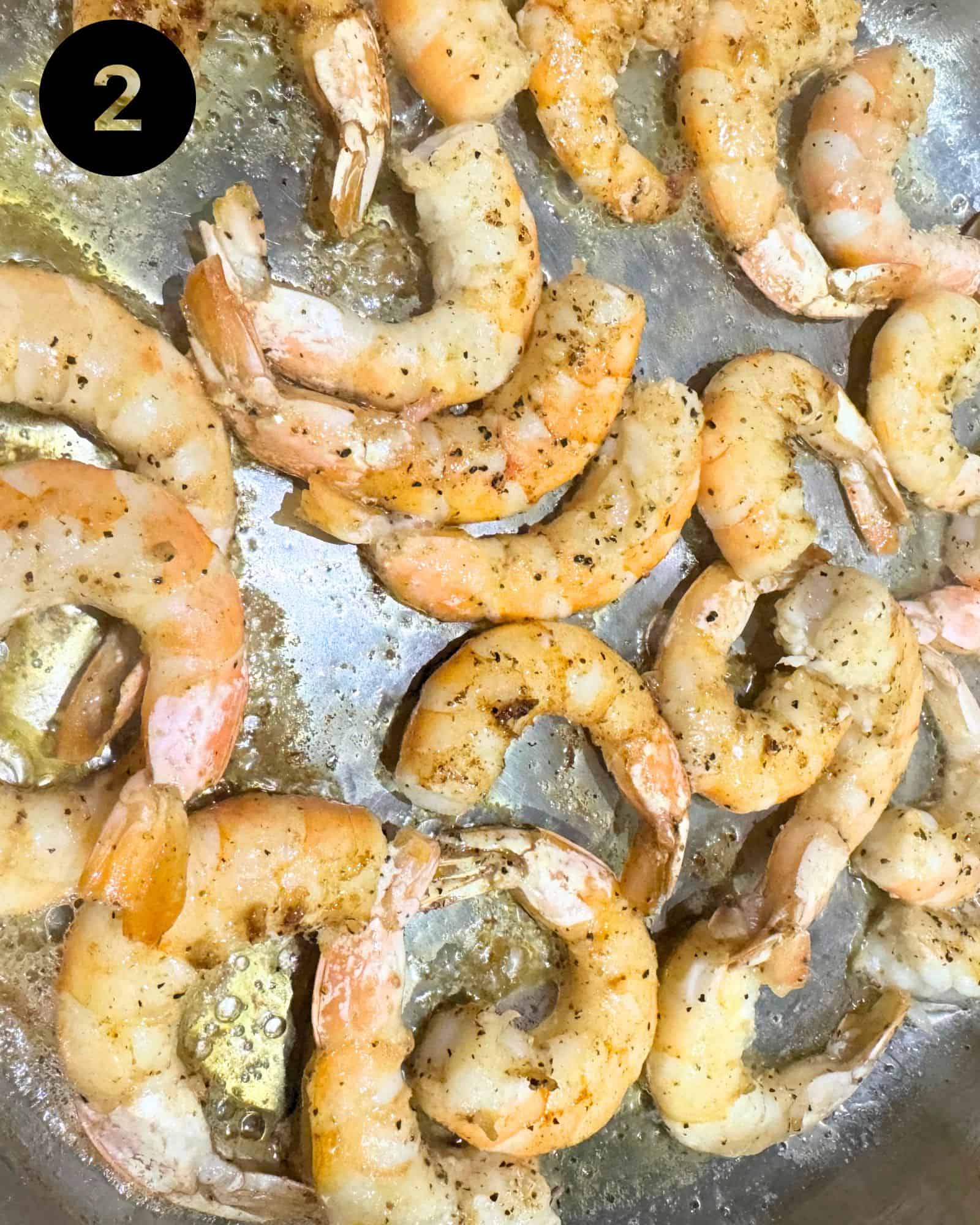 shrimp being cooked in a saute pan
