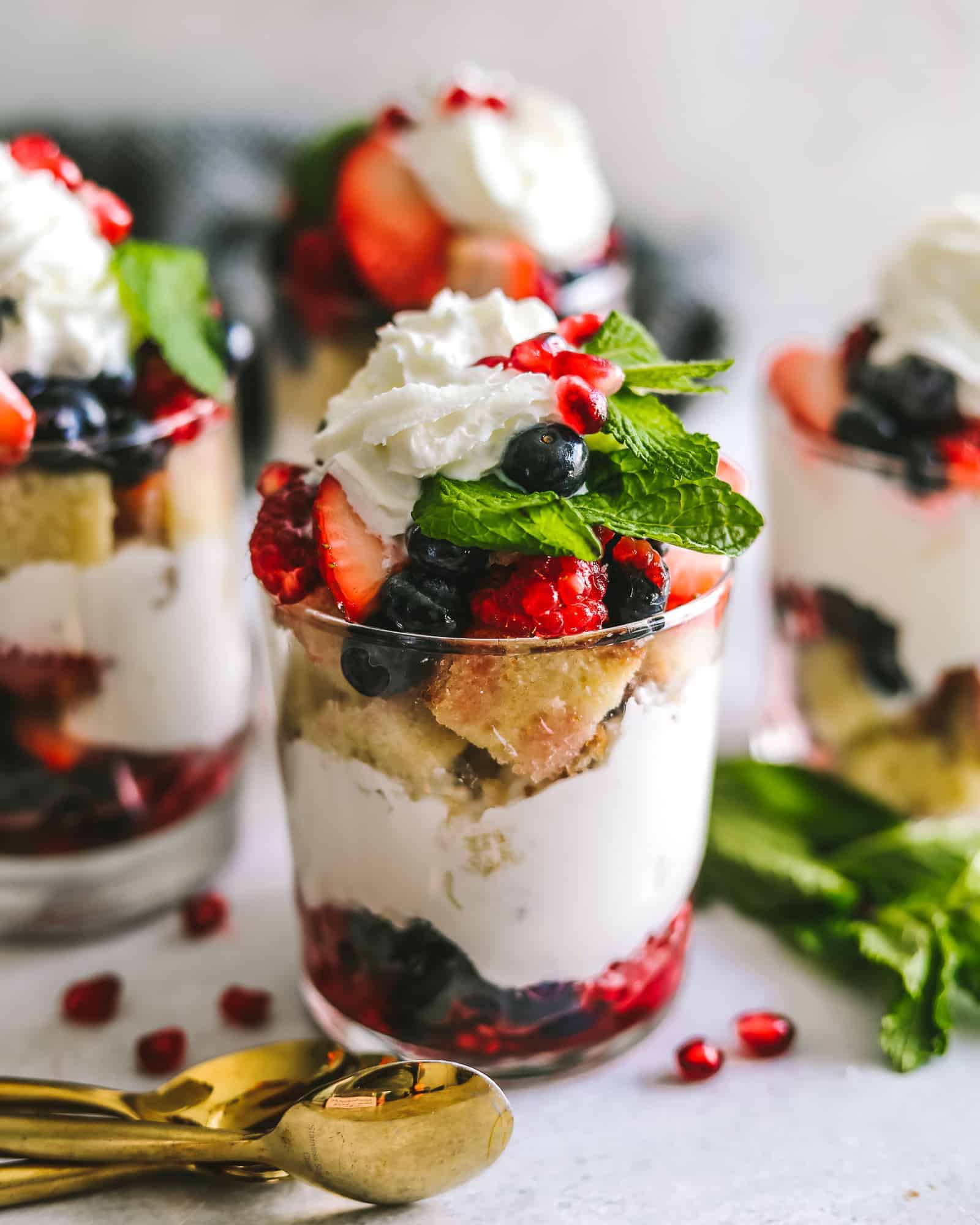 Mixed Berry Trifles in a cup with berries and spoons