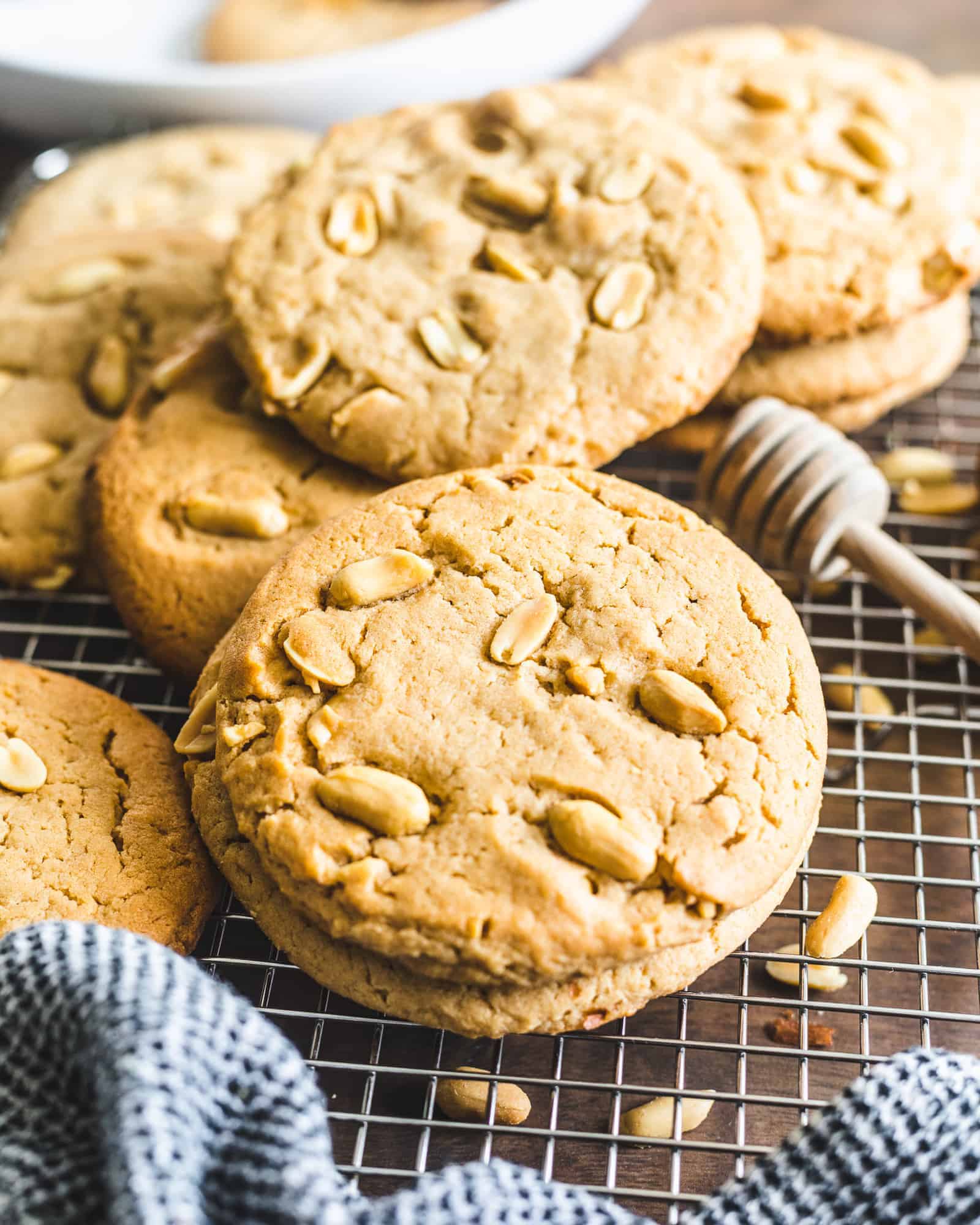 Honey Peanut Butter Cookies on a cooling rack with a cloth