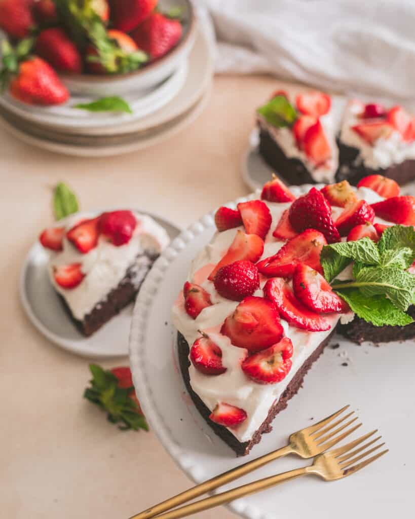 Strawberries and cream chocolate cake on a cake stand