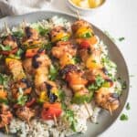 Grilled Pineapple Chicken Skewers on a plate with rice