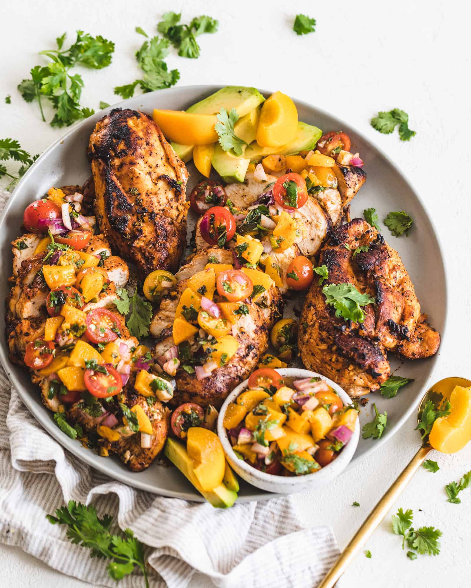 Honey Garlic Chicken topped with peach salsa on a plate