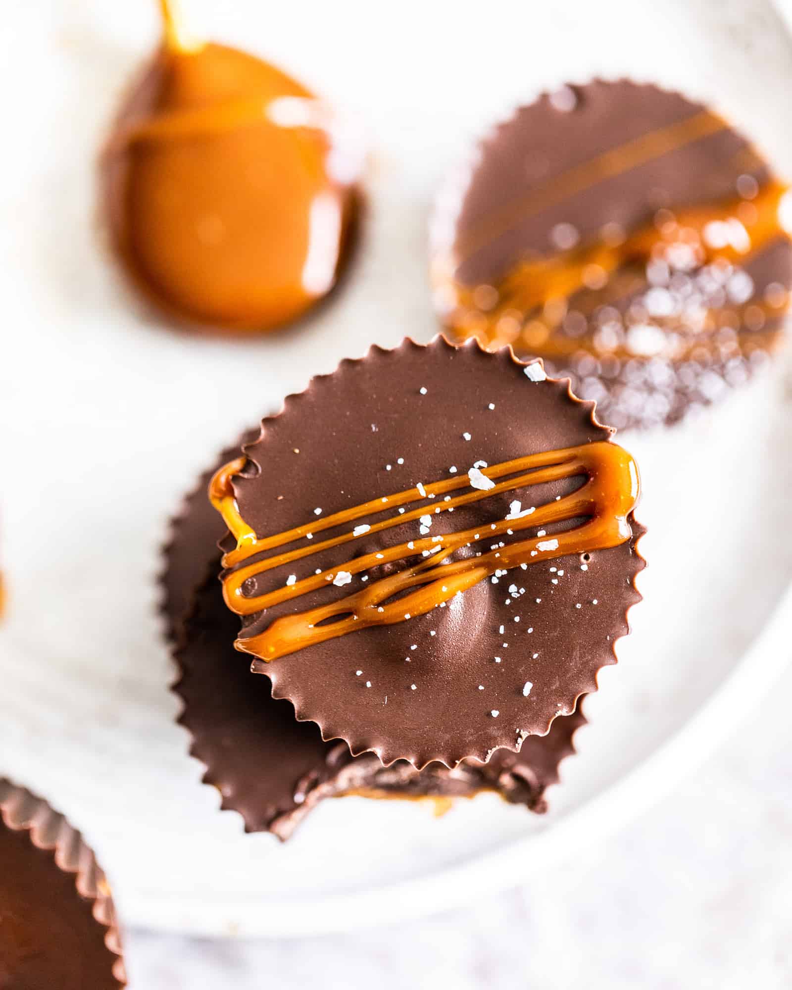overhead photo of caramel drizzled on peanut butter cups