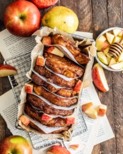 Apple Pear Fritters with Honey Glaze in a Loaf Pan surrounded by apples and a pear