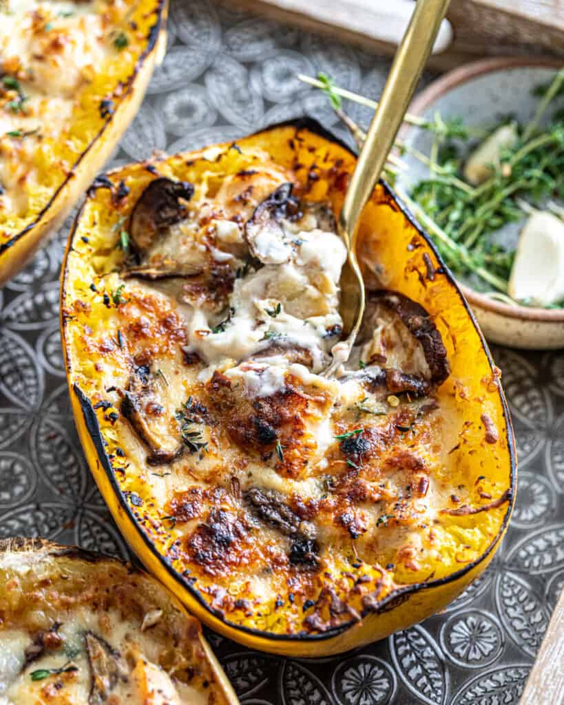 Spaghetti Squash on a tray with fresh herbs in the background