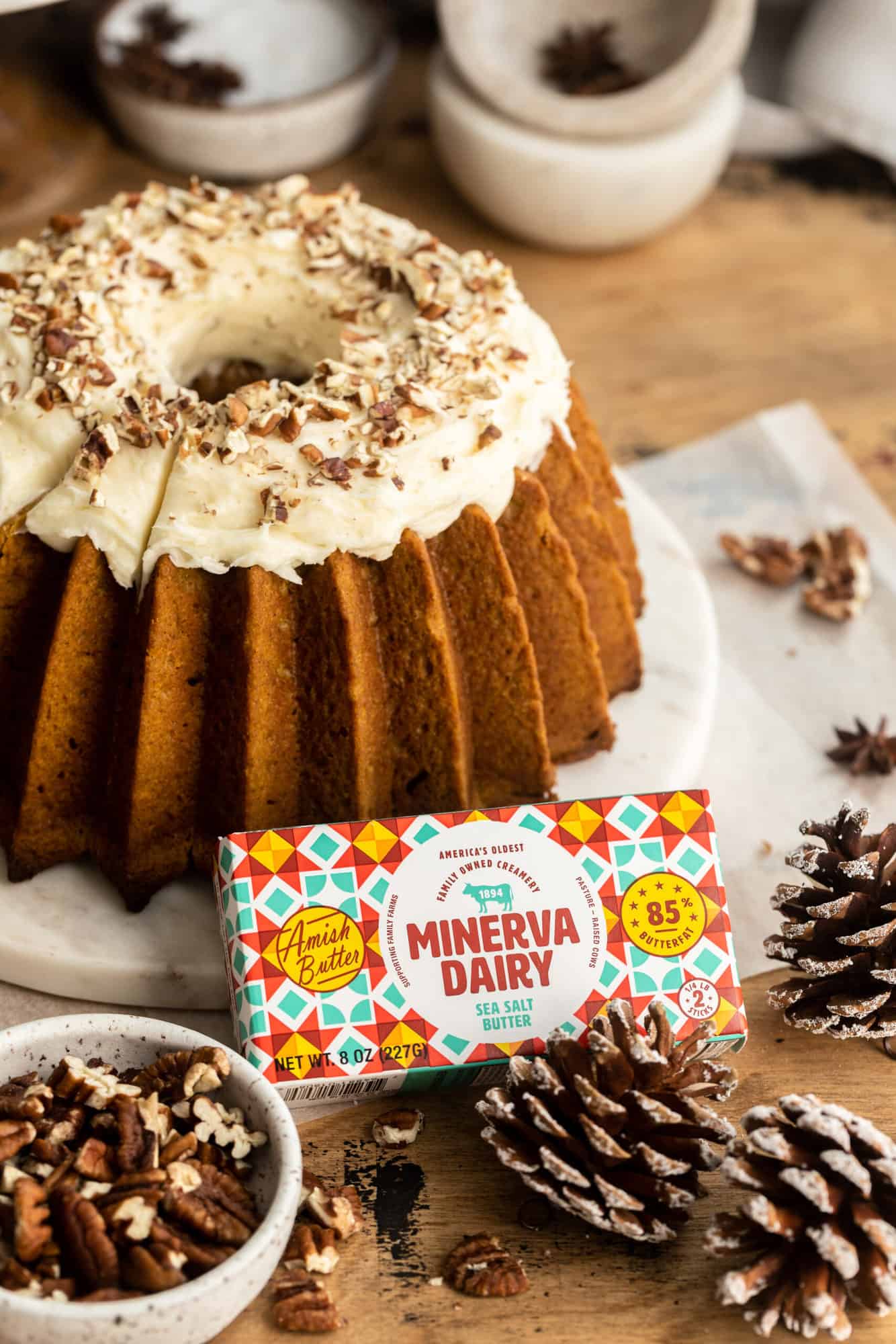 A whole plated Sweet Potato Pound Cake with a package of Minerva Dairy Butter placed in front of it.
