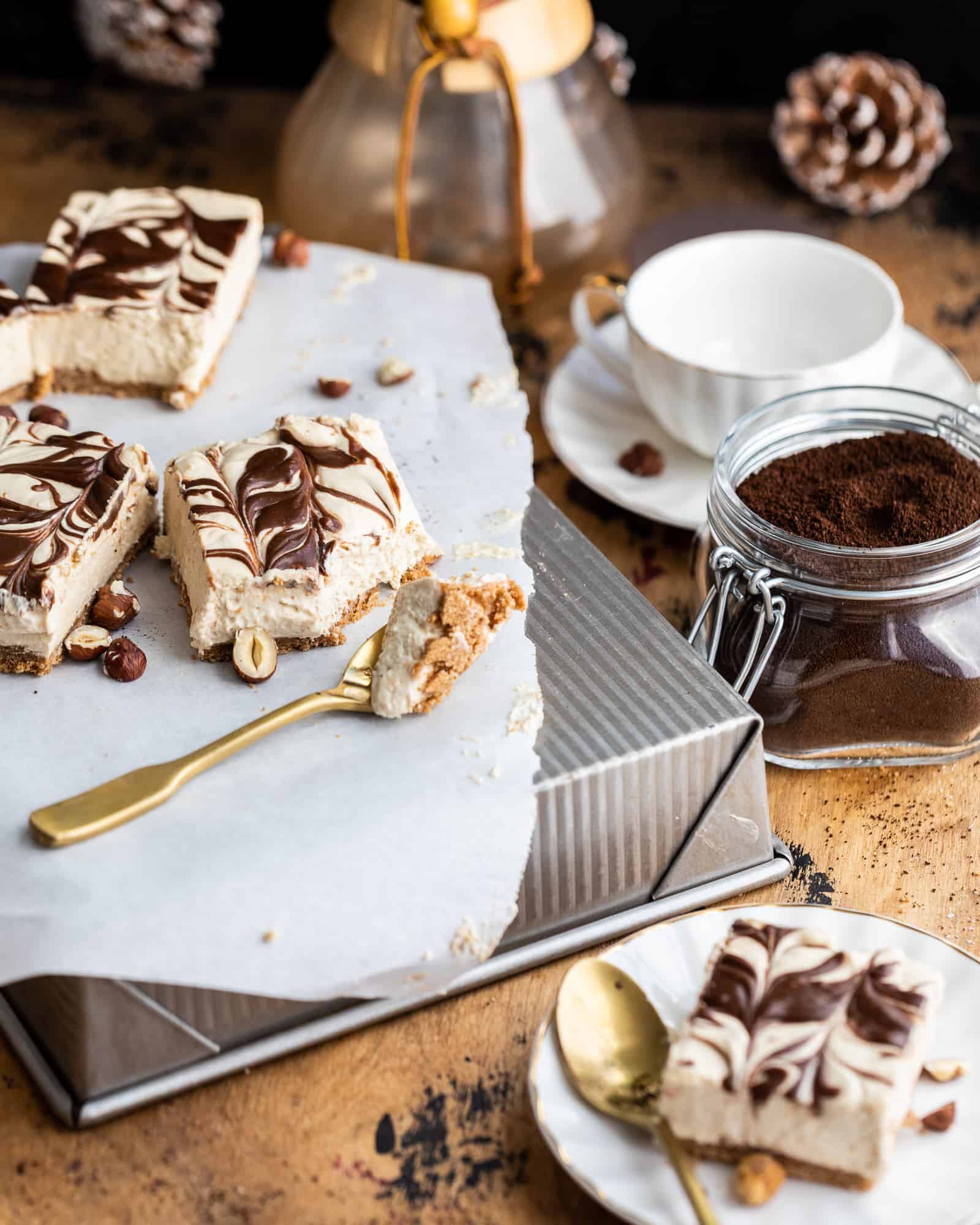 mocha peanut butter cheesecake bars cut into 5 pieces on top of a baking pan