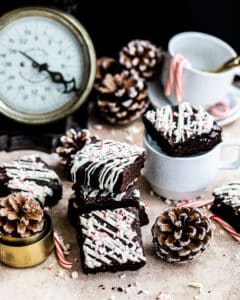 brownies stacked together next to a pine cone and tea cups