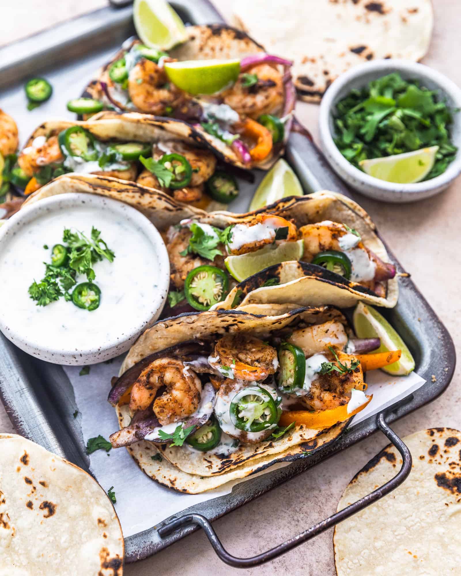 cajun shrimp tacos with garlic lime ranch on a serving tray