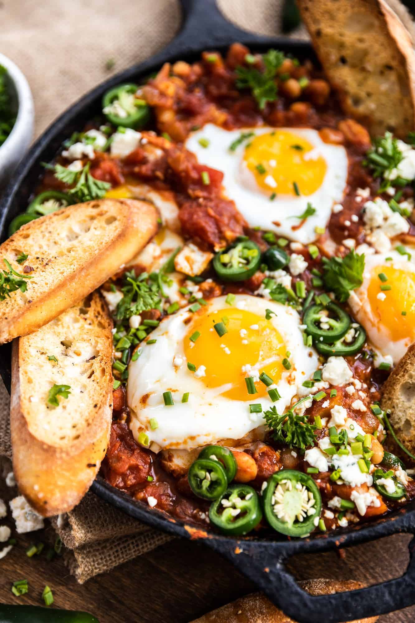 spicy white bean shakshuka in a cast iron skillet