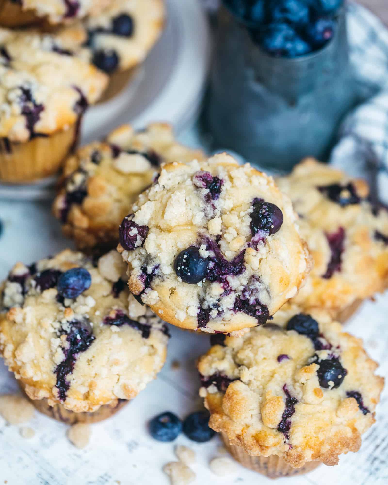 blueberry crumb cake muffins on top of each other in a bowl