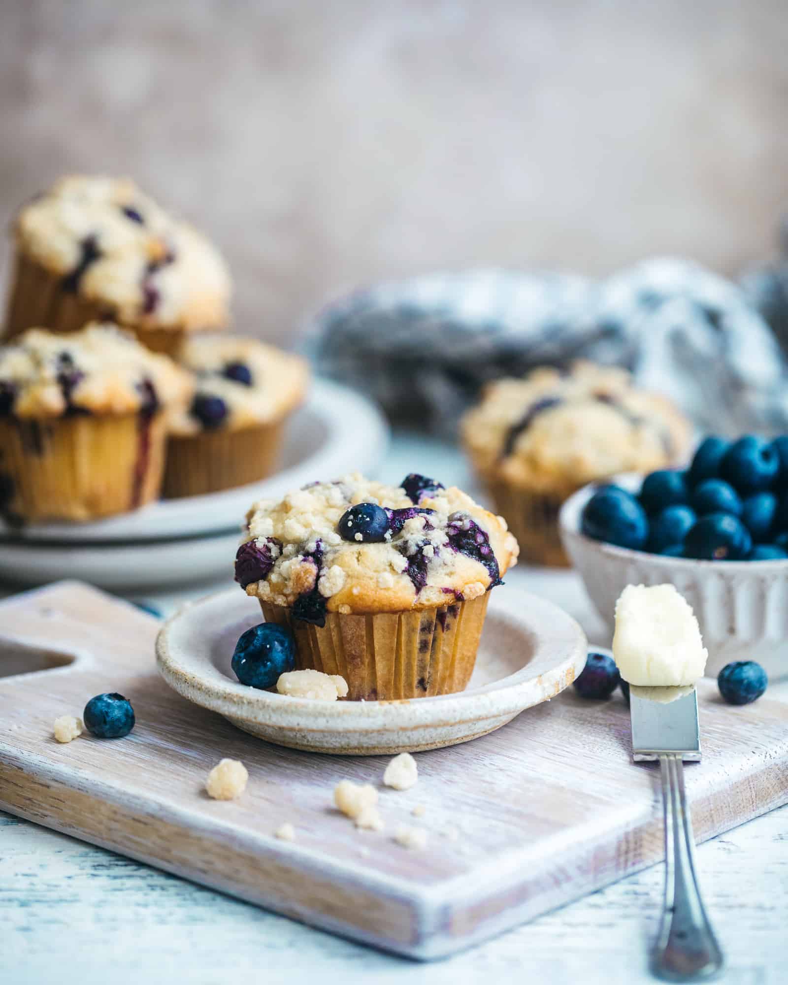 blueberry crumb cake muffins on a plate 