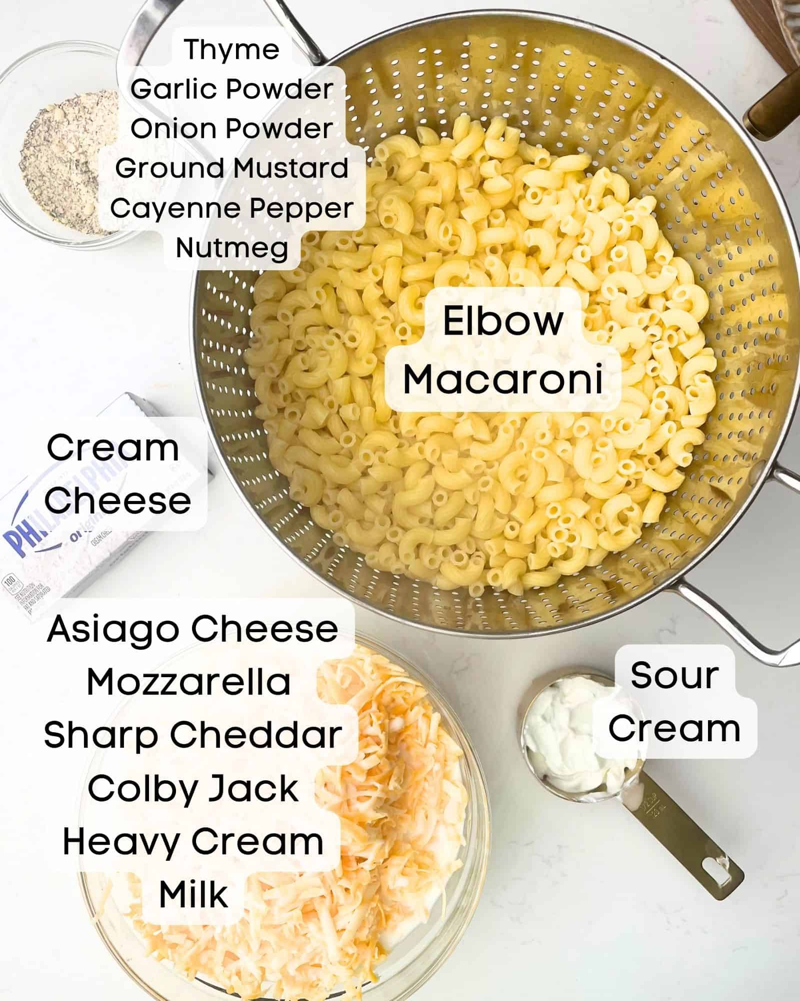 ingredients to make mac and cheese - elbow macaroni, seasonings, sour cream, heavy cream, whole milk, cream cheese, cheddar cheese, asiago cheese, colby jack cheese, and mozzarella cheese.