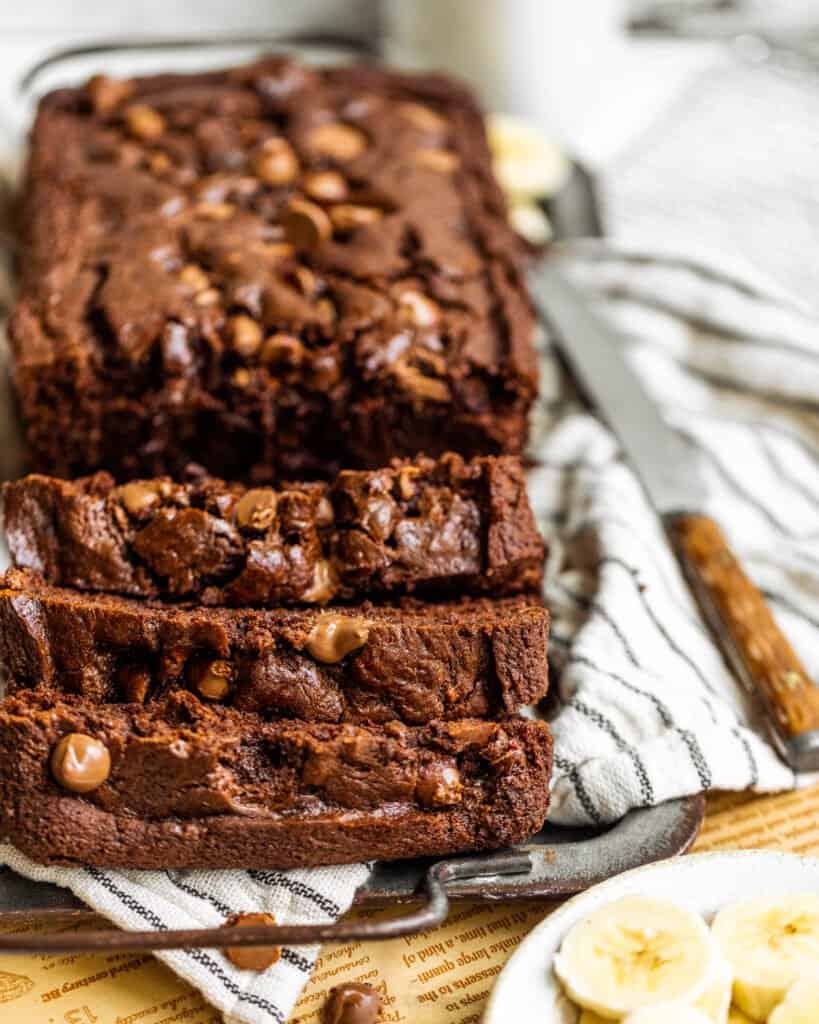 sliced chocolate banana bread with a butter knife