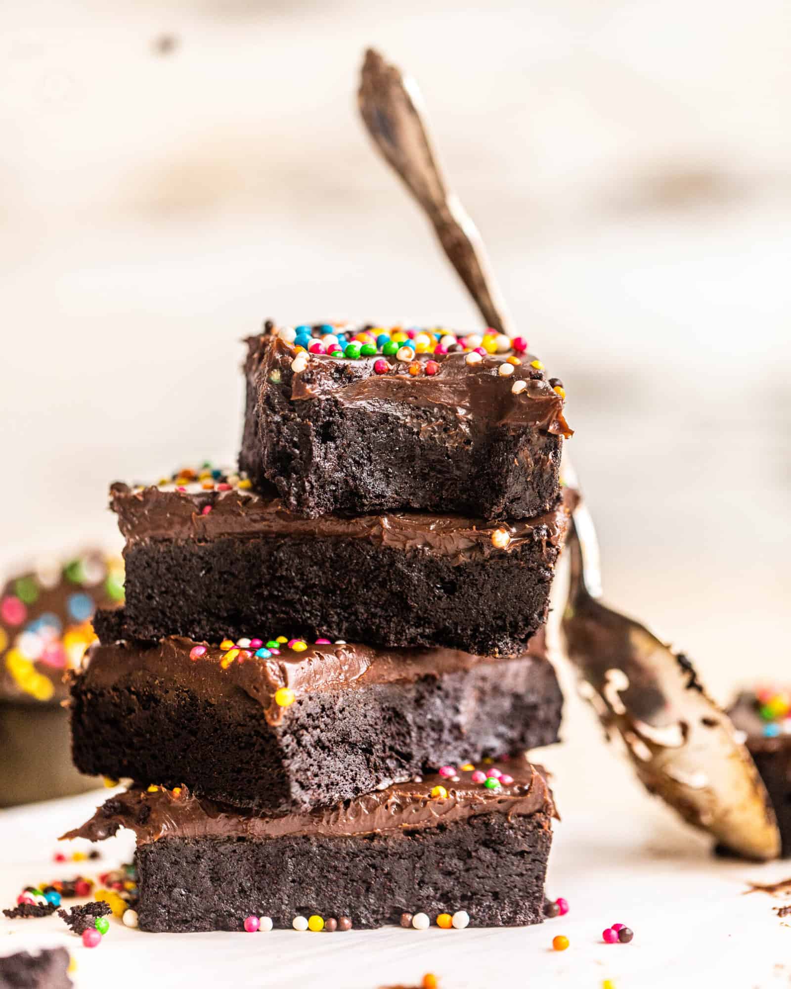 brownies stacked on top of one another with a spoon