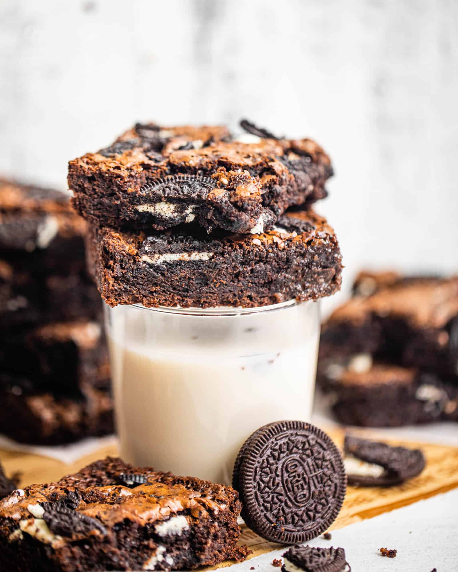 brownies stacked on top of a glass of milk