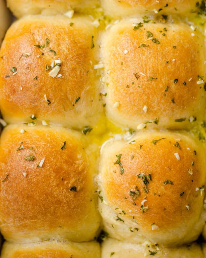 macro photo of dinner rolls up close with melted garlic butter