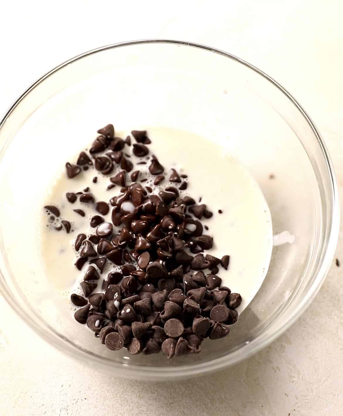 heavy cream and chocolate chips in a bowl to prepare the chocolate ganache