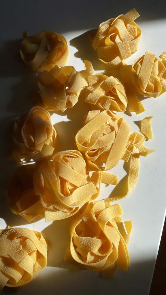 dried pappardelle bunches on a marble surface