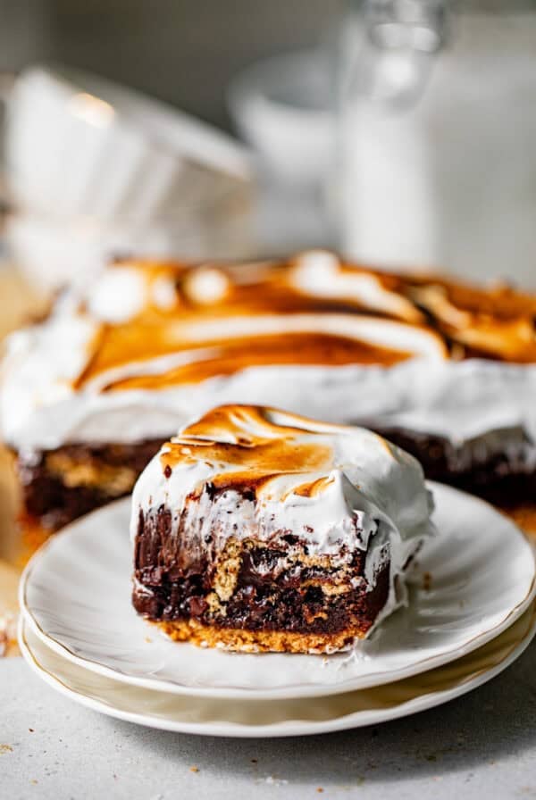 smores brownies on a small plate with a toasted homemade marshmallow top.