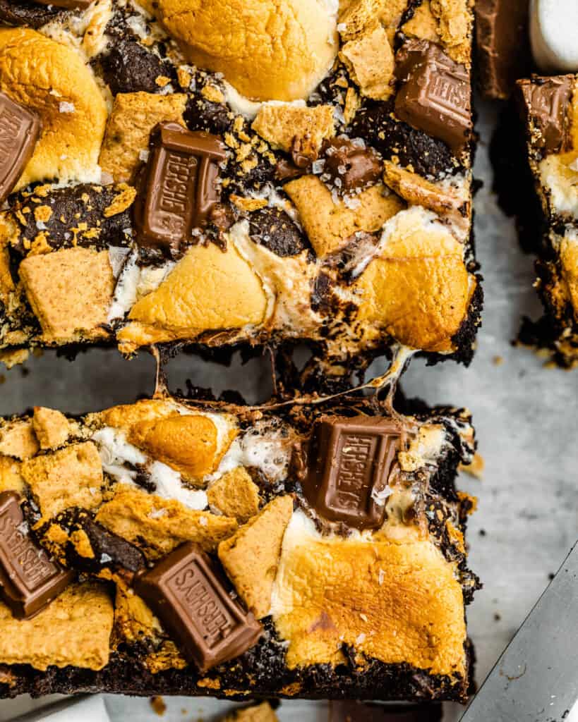 graham crackers, chocoately, and marshmallows on top of a brownie