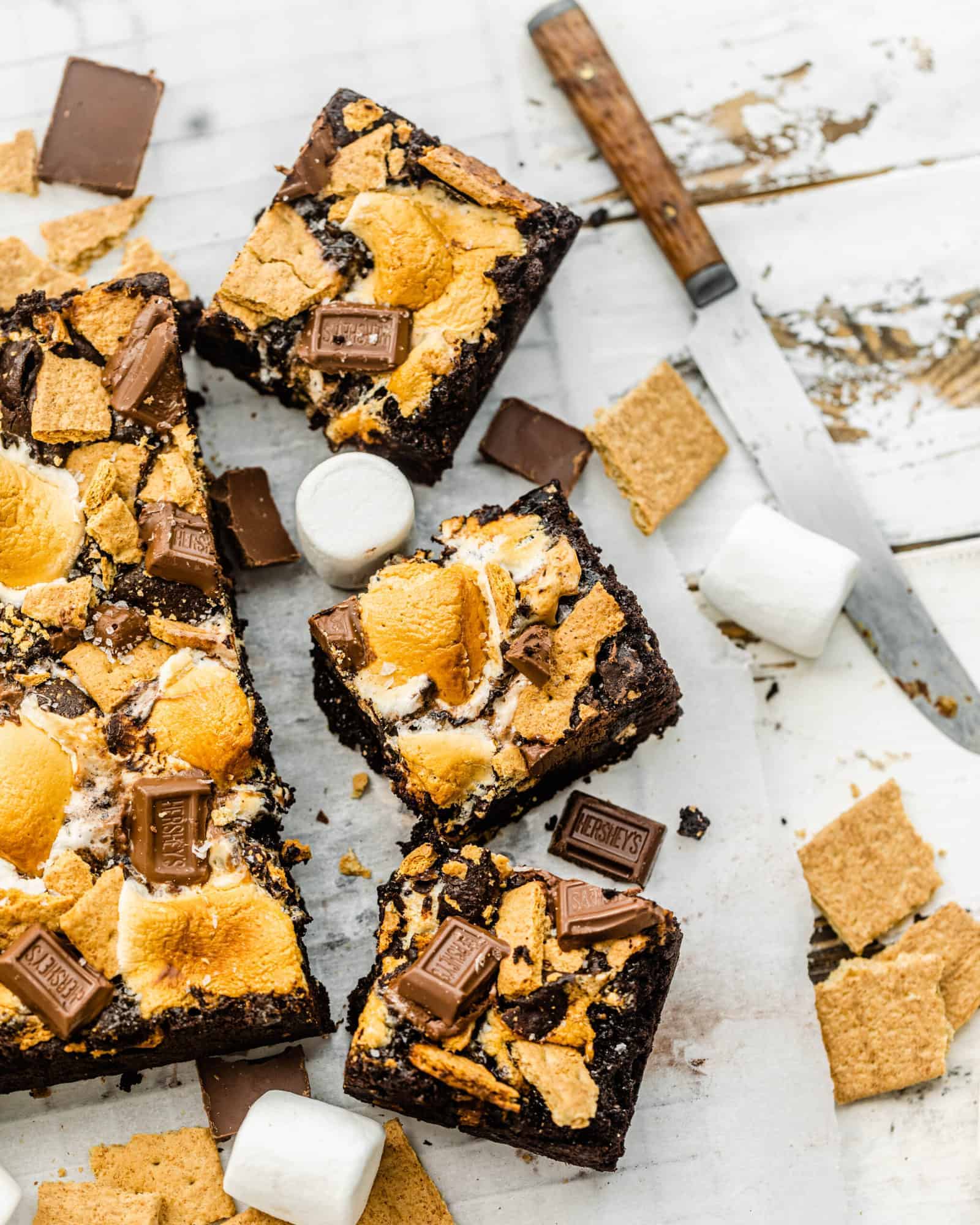 s'mores brownies sliced into squares with graham crackers and marshmallows