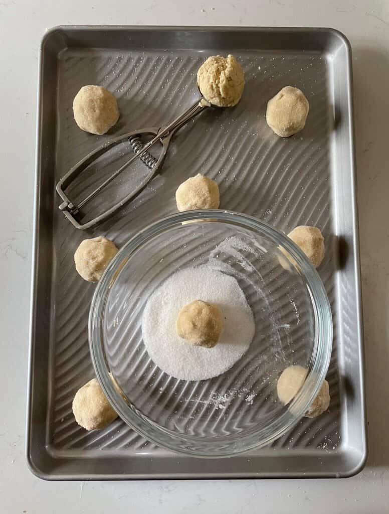 rolled balls of cookie dough on a cookie sheet