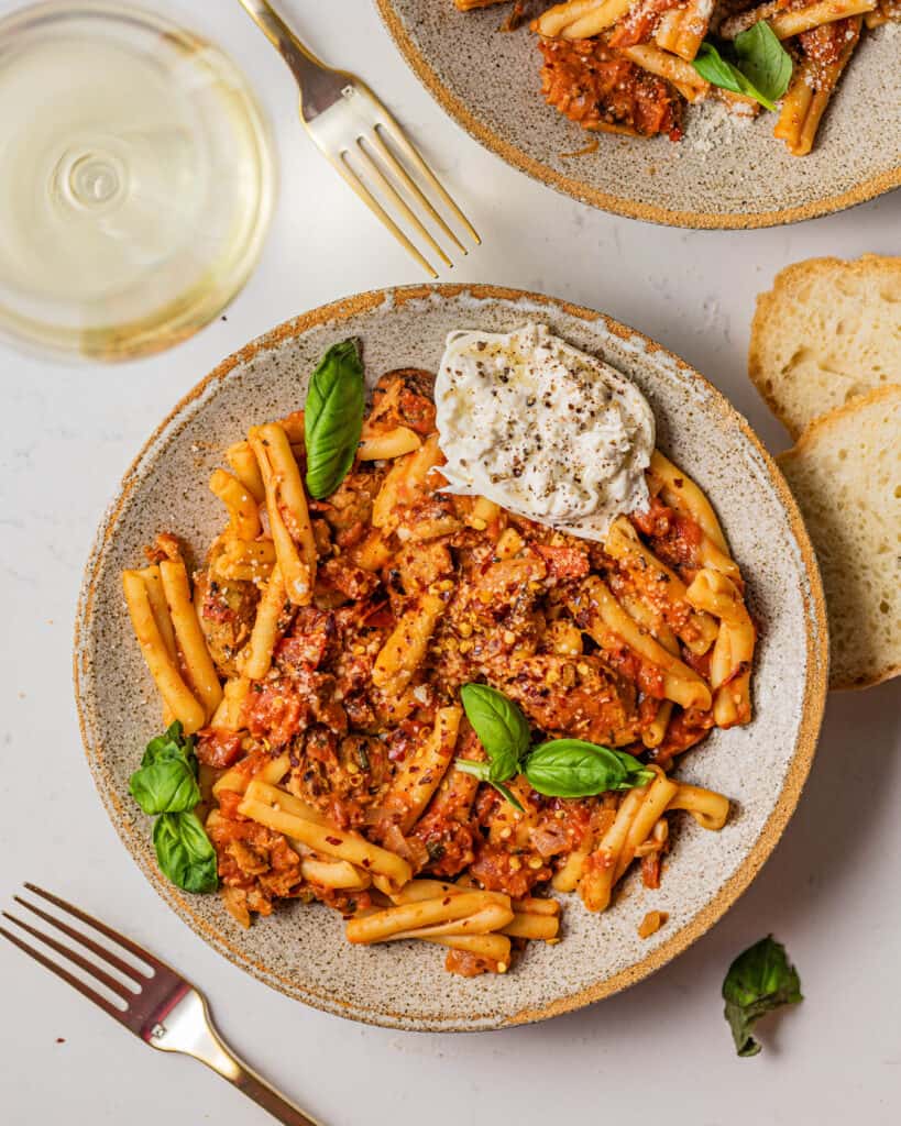 casarecce pasta in a bowl with burrata and fresh basil