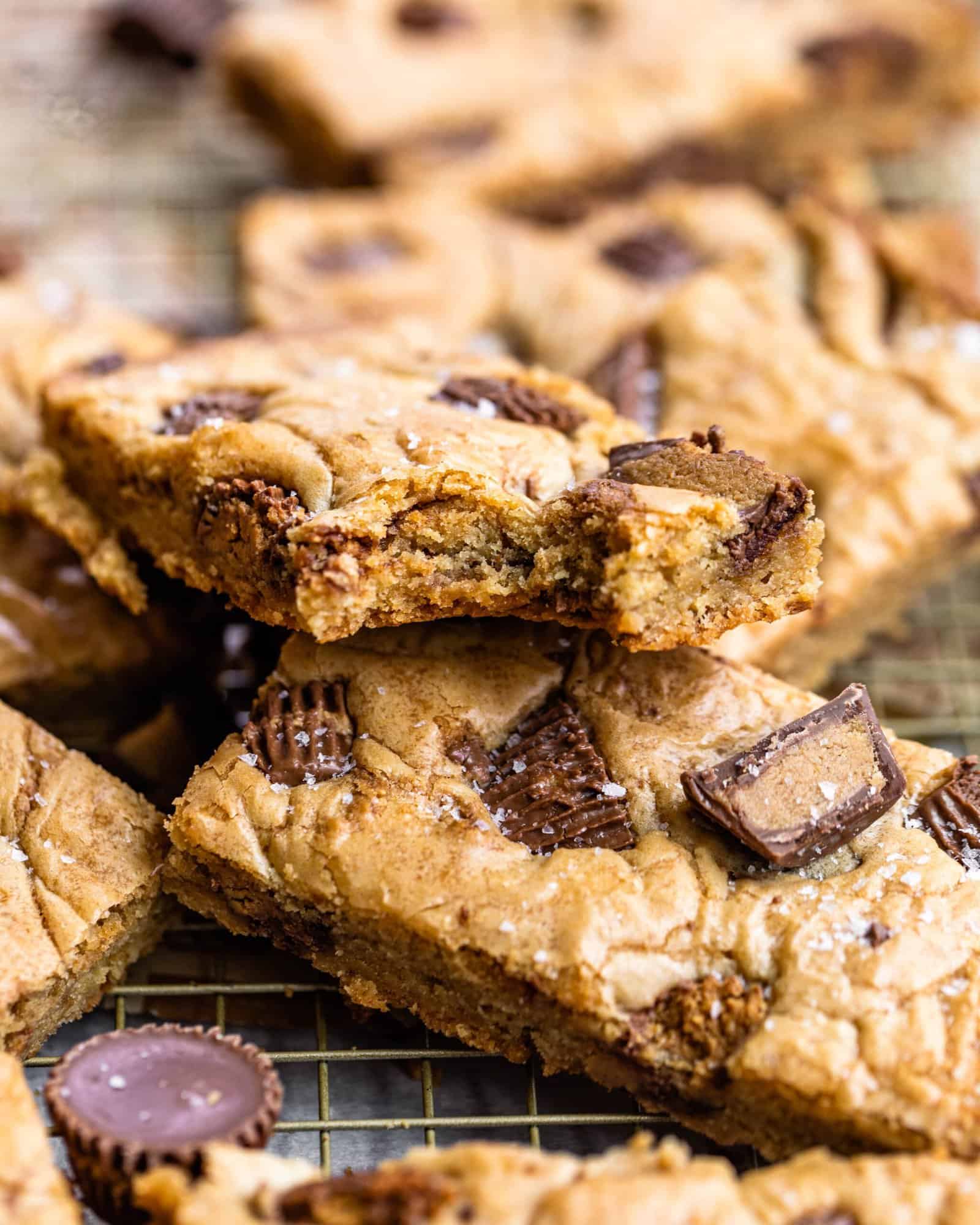 a blondies with a bite taken out of it with peanut butter cups