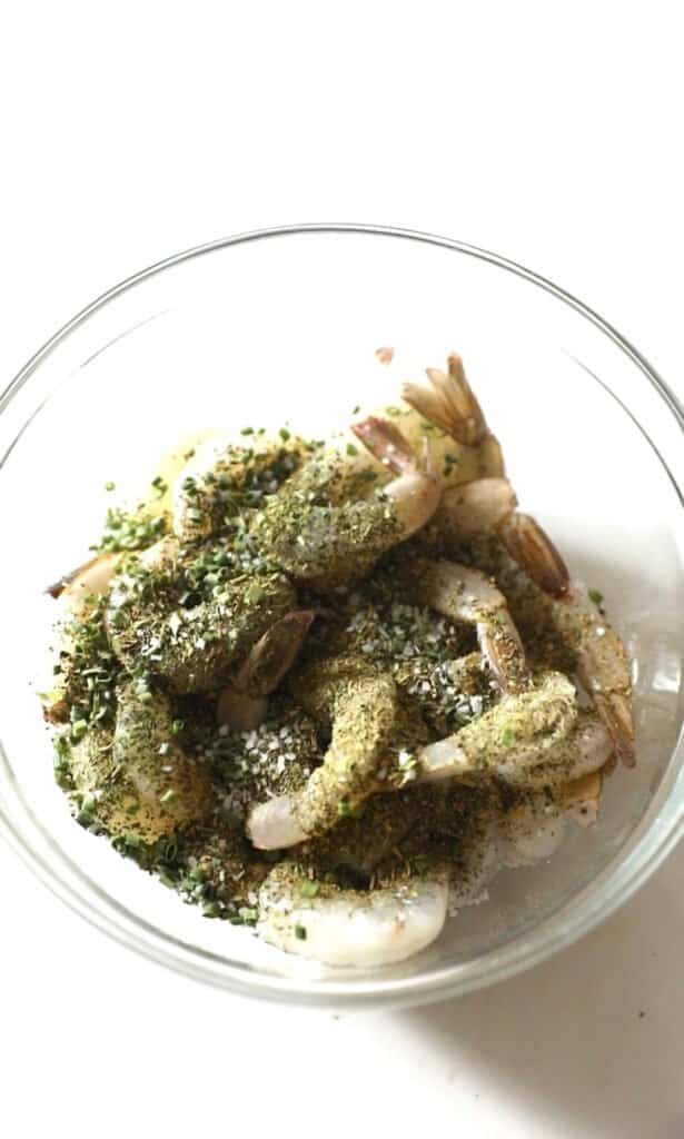 shrimp in a bowl wit seasonings on top