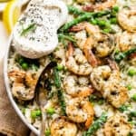 shrimp and risotto in a bowl with burrata and vegetables