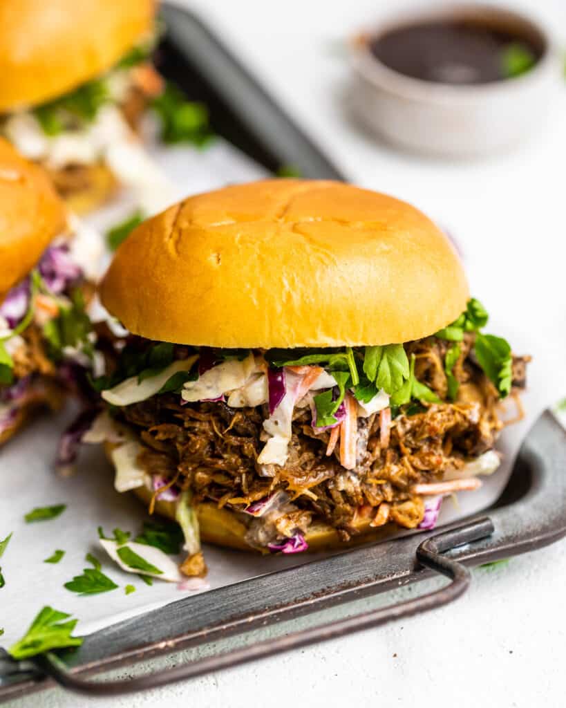 a bbq pulled pork sandwich on a serving dish