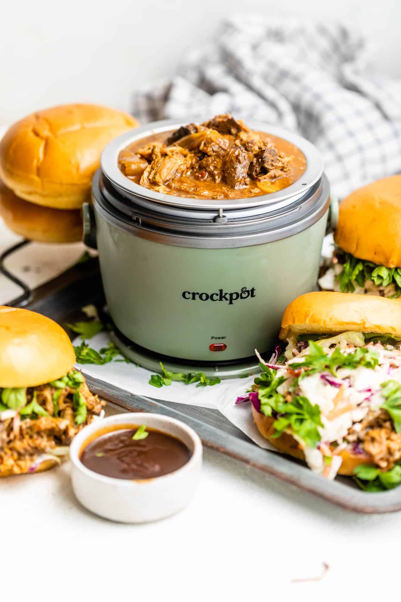 lunch crock pot on a dish with sandwiches