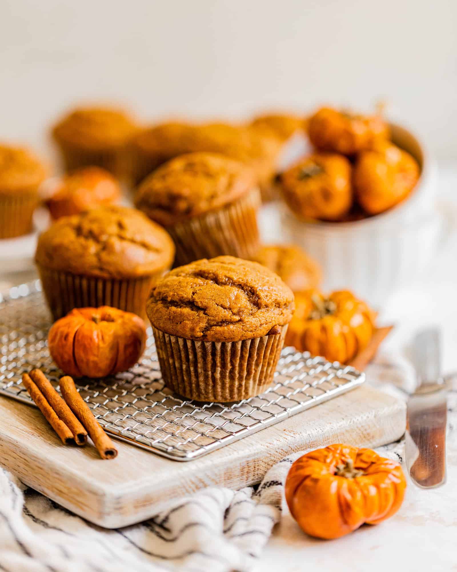 pumpkin muffins on a board with mini pumpkins