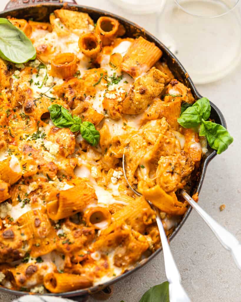 buffalo chicken pasta in a skillet with two spoons