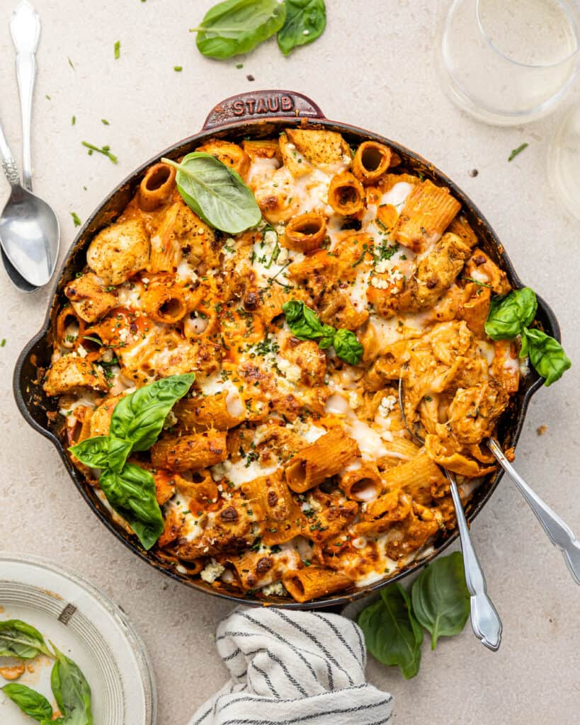 buffalo chicken pasta in a large skillet garnished with basil