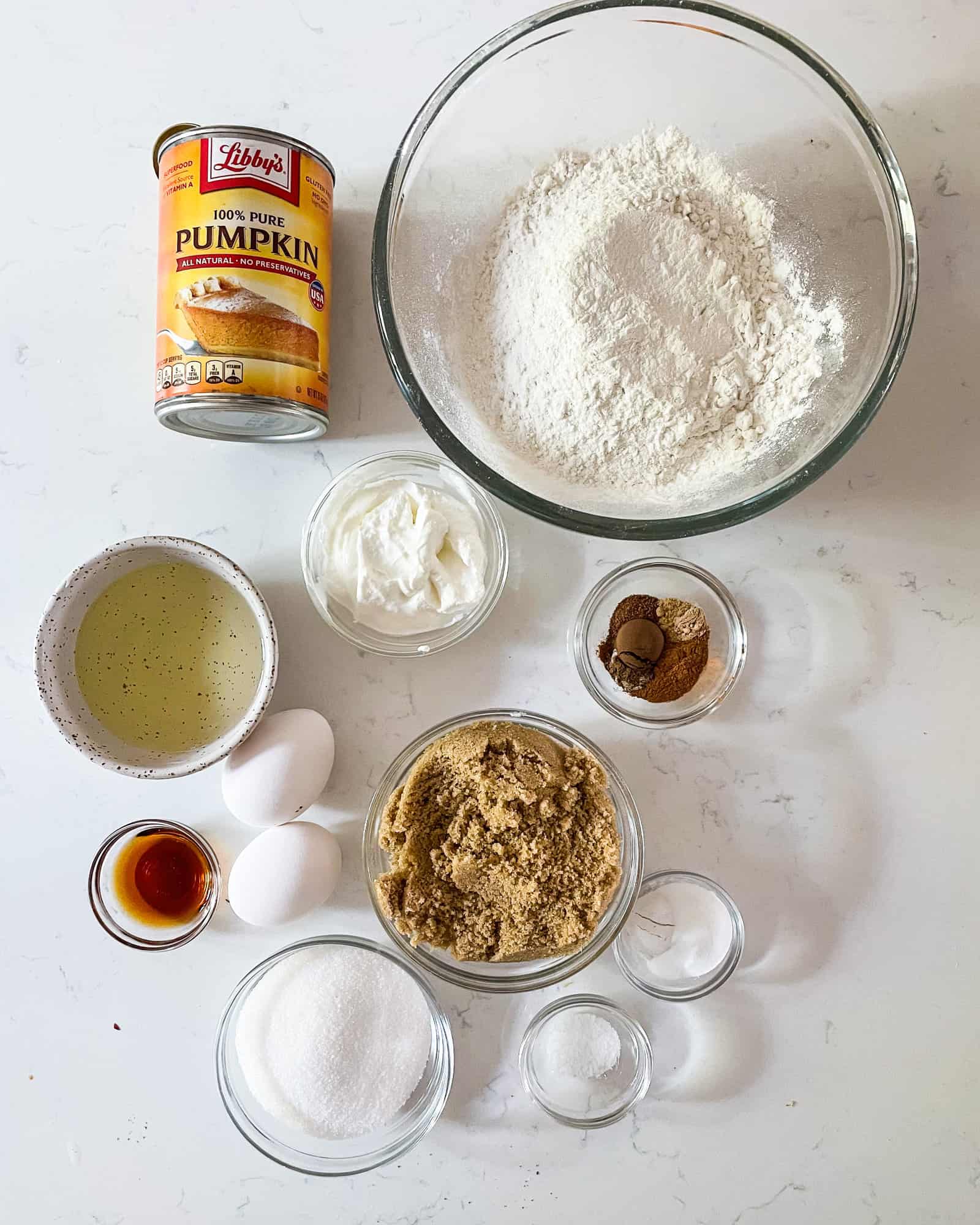 ingredients to make pumpkin muffins in bowls